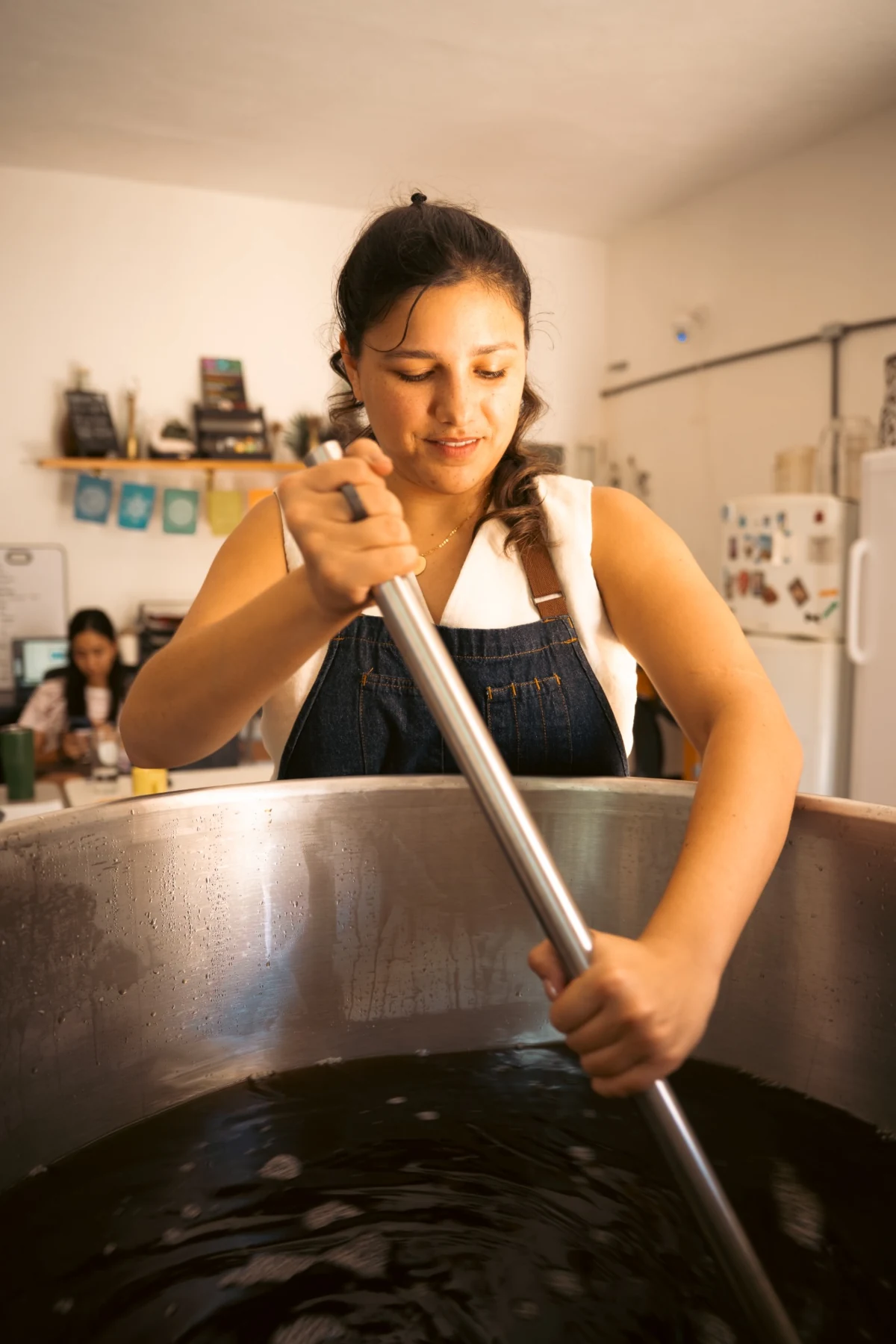Sol tending a Golden Sands fermentation vessel
